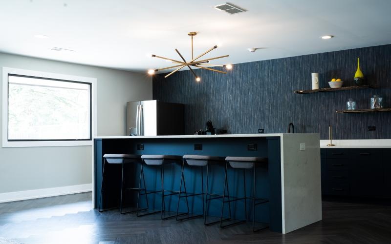 a kitchen with a bar and stools