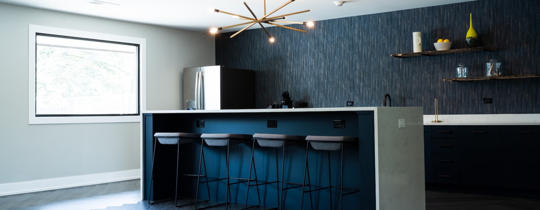 a kitchen with a bar and stools