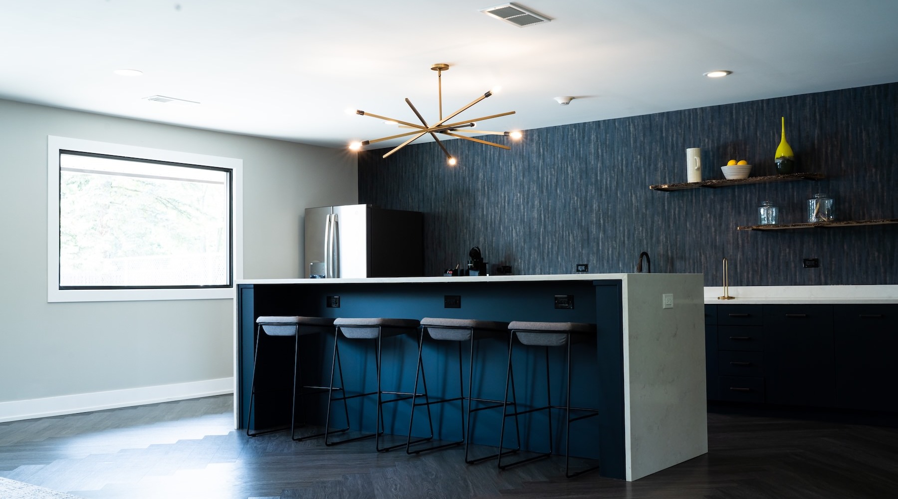 a kitchen with an island and chairs