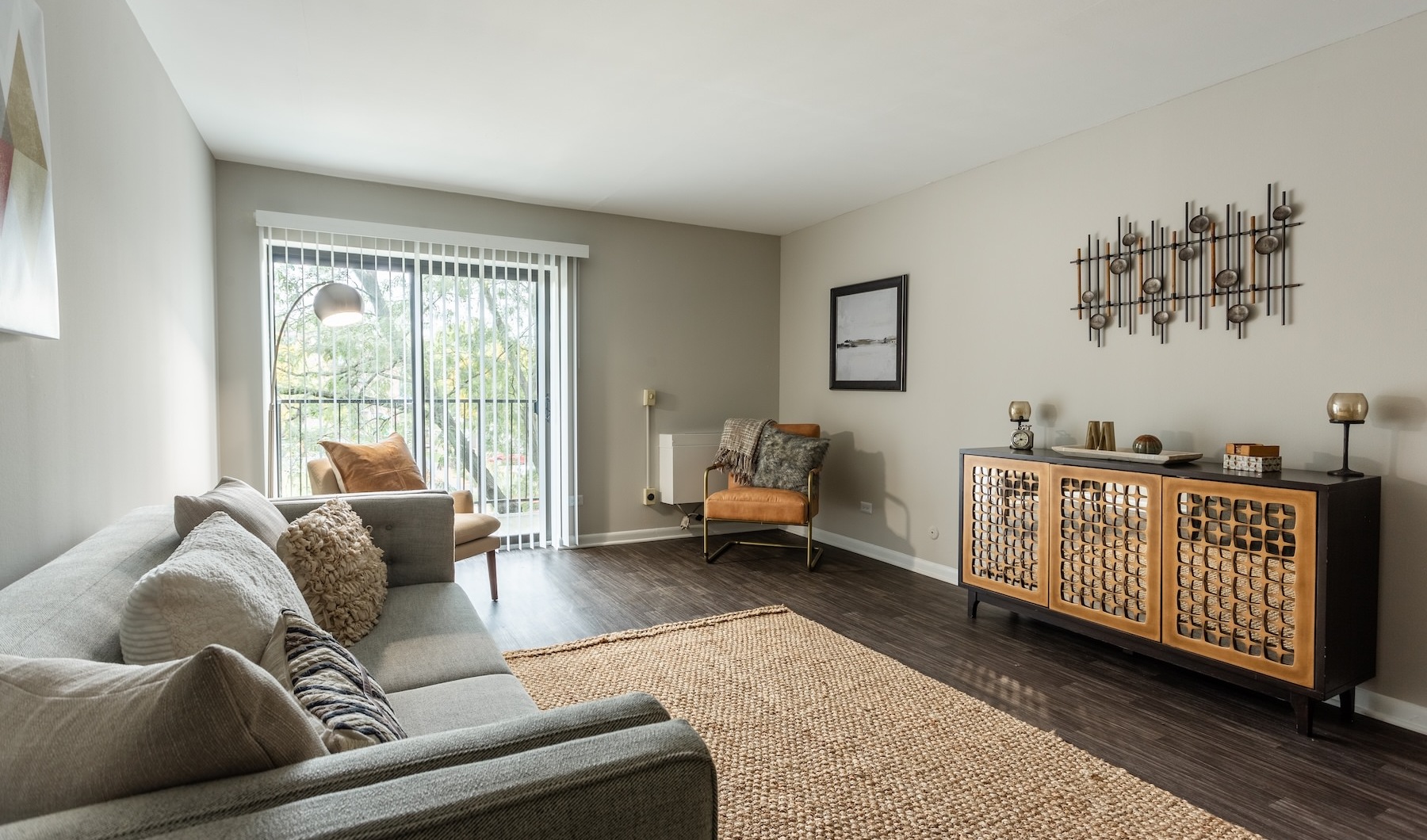 a living room with a couch, chairs and a media console
