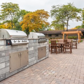 a grill area with tables and chairs